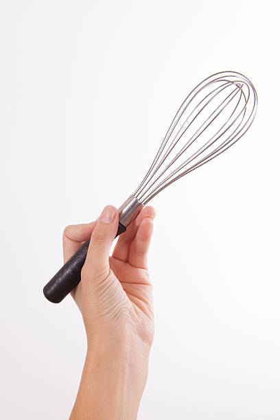 istock Stainless steel egg whisk in woman hand 508174311