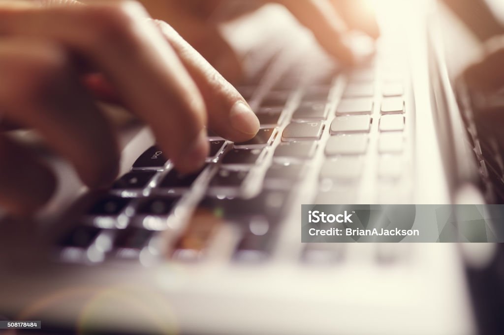 Hands typing on laptop computer Businessman using laptop computer Computer Keyboard Stock Photo