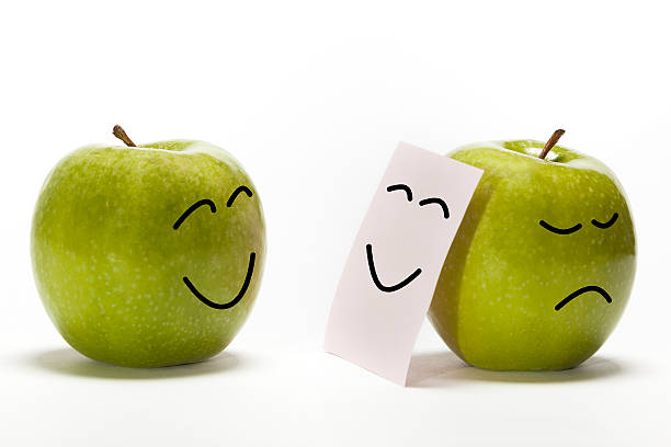 Fakeing Feelings Stock Photo - Download Image Now - Cheesy Grin, Apple - Fruit, iStock