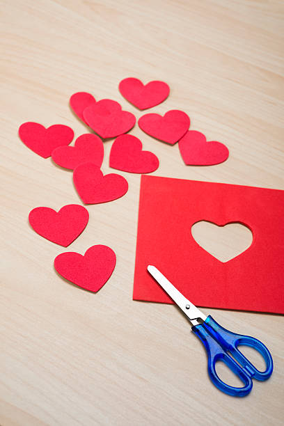 istock Cutting heart shapes from red foam sheets with scissors 508179866