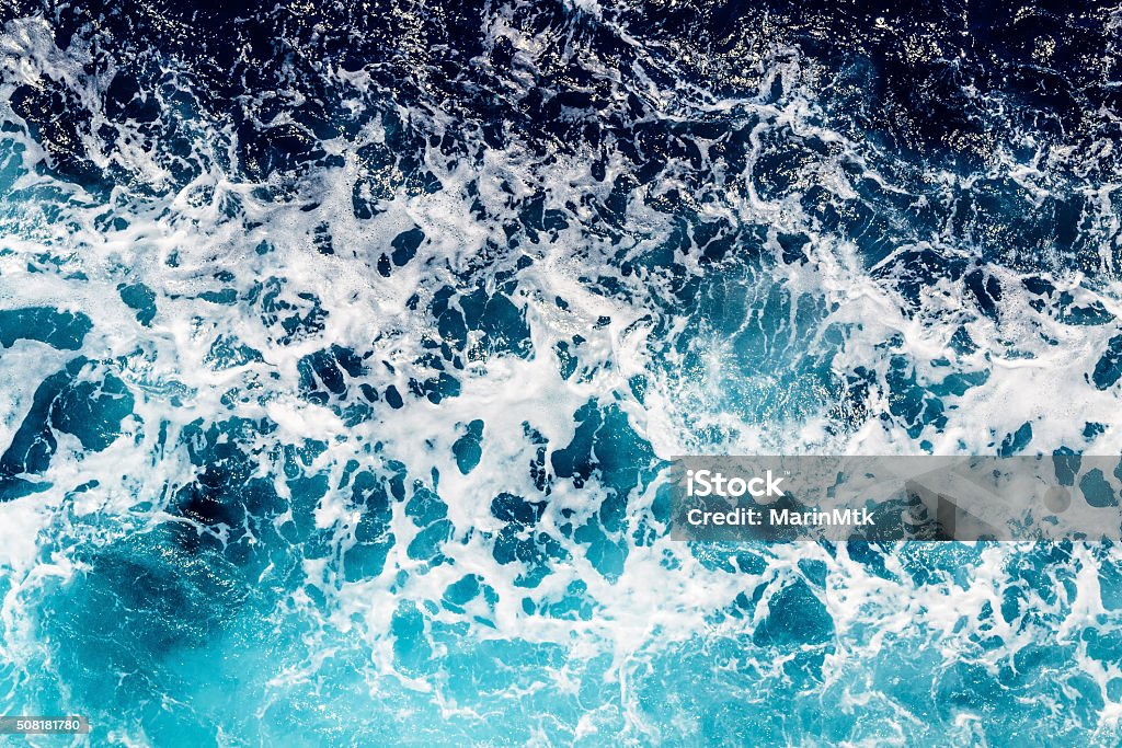 Deep blue sea water with spray Areal shot of deep blue and rough sea with lot of sea spray Sea Stock Photo