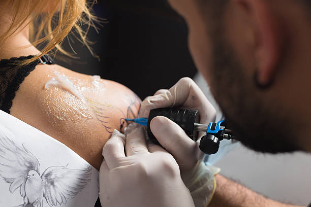 istock He is making tattoo on the a girl 508182712