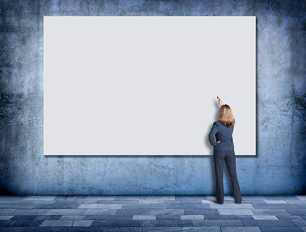 istock Businesswoman Using Marker To Write On large White Sign 508183304