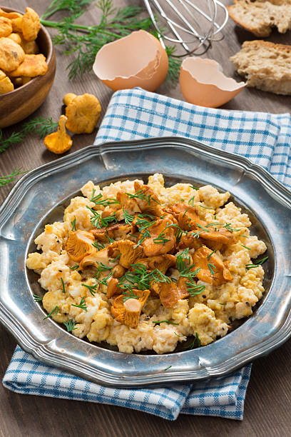istock scrambled eggs with chanterelles and fresh dill on a plate 508185395