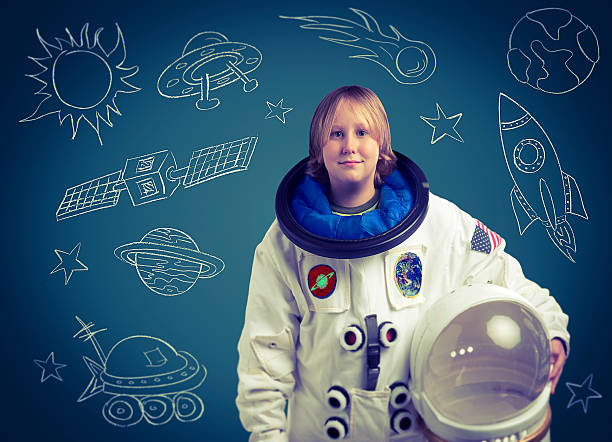 istock Astronaut Child in Front of Chalkboard Outer Space Drawings 508186586