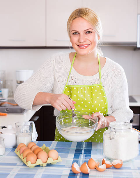 istock Housewife beating eggs and milk in bowl 508186928