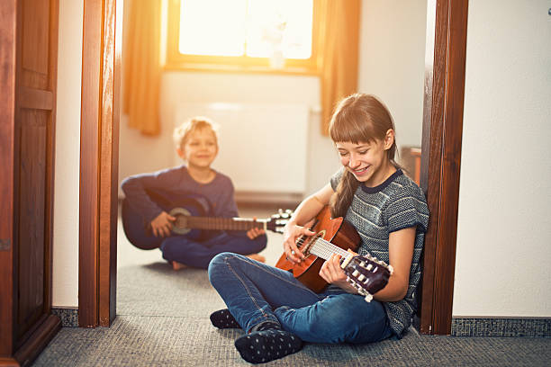 istock Sister and brother having fun playing guitars 508187100