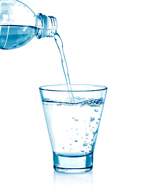 istock pouring water on a glass on white 508187388