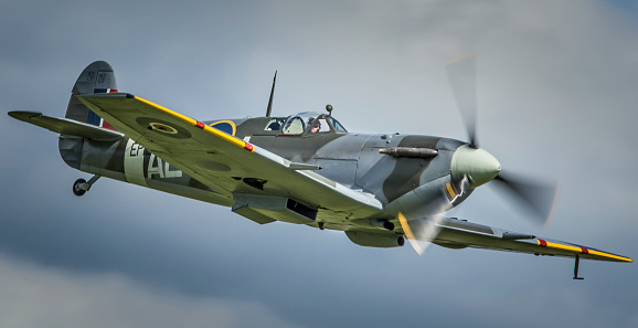 Duxford, UK - May 25, 2014: a vintage Spitfire Mk 5 fighter aircraft which saw active service in World War Two is seen in flight at an air show in Cambridgeshire, England.