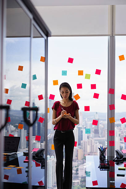 istock Busy Business Woman Writing Tasks On Adhesive Notes 508188386