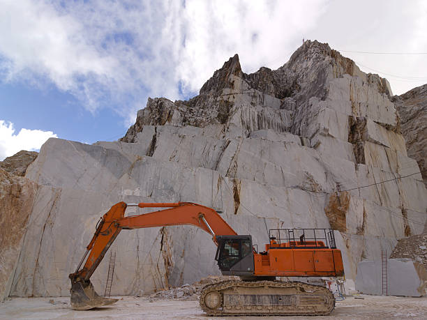 istock Orange Excavator in a white marble quarry in Carrara 508189560