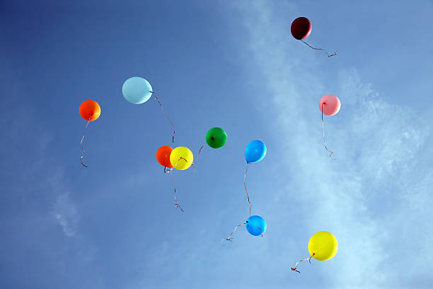 istock colored balloons flying in the blue sky 508189816