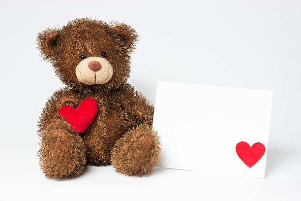 istock Teddy bear with heart and card on a white background 508191288