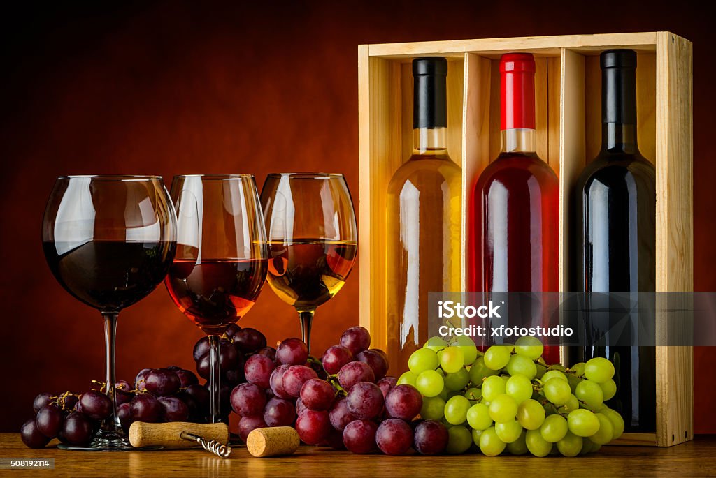 Red, Rose, and White Wine in Glass and Bottle Three glasses and bottles of wine. White, red, and rose wine. Alcohol - Drink Stock Photo
