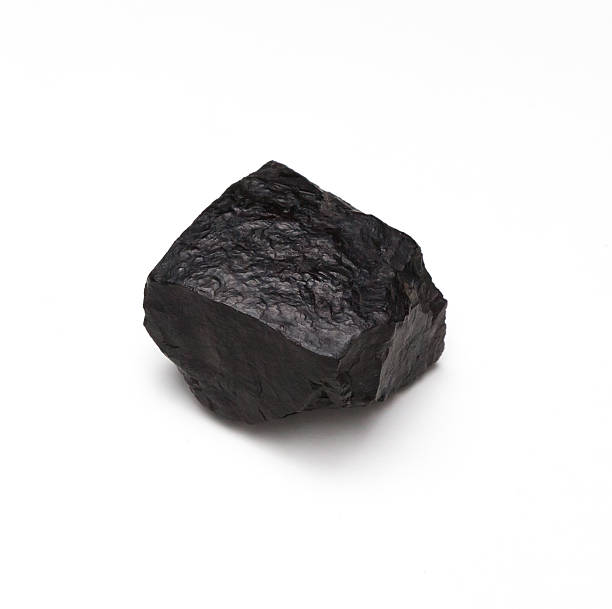 Chunk of Coal on a White Background Lump of coal isolated on a white background bumpy photos stock pictures, royalty-free photos & images