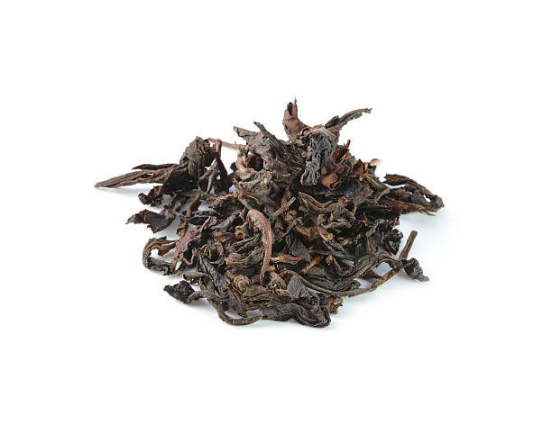 istock dry black tea leaves isolated on white 508198931