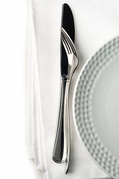 istock Knife and fork on white linnen napkin. 508199805