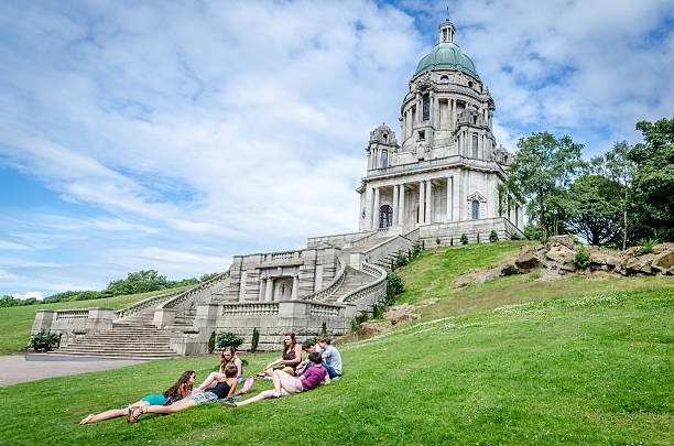 Friends relaxing at the Ashton Memorial Lancaster, United Kingdom - July 7, 2014: People socialising at Ashton Memorial in Williamson's Park ashton idaho photos stock pictures, royalty-free photos & images