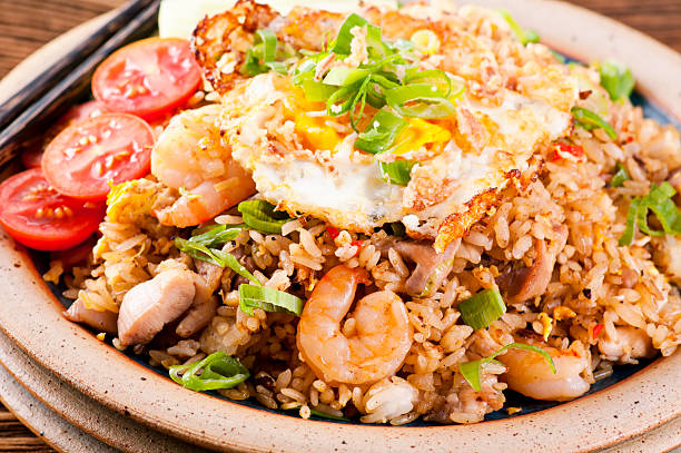 Nasi Goreng with fried egg, chicken and shrimp stock photo