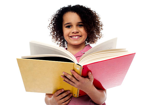 istock Adorable school girl reading a book with a smile 508200377