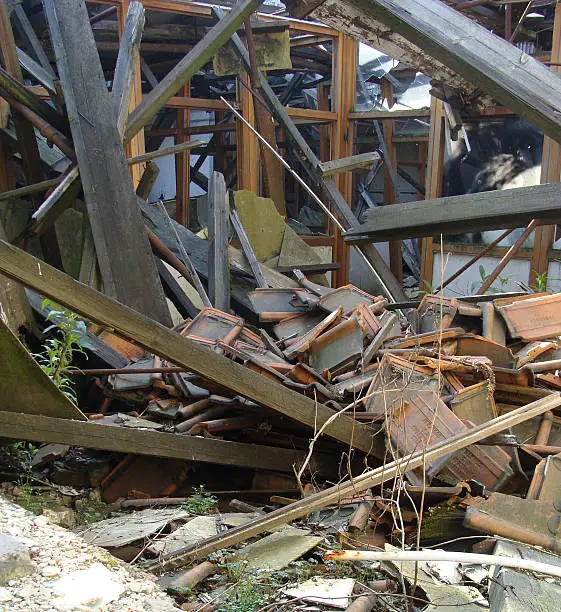 collapsed roof showing wood glass,and stone rubble