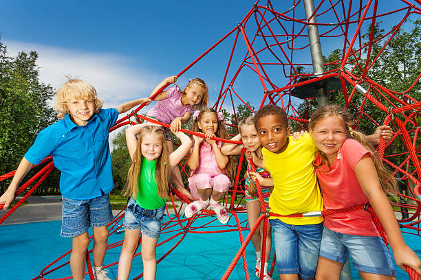 istock Group of children stand on red ropes and play 508201281