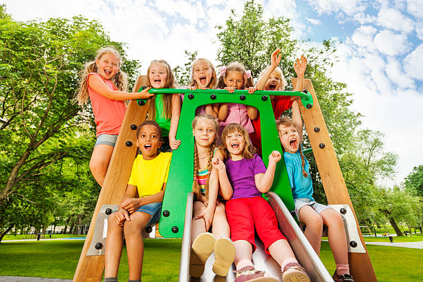 istock Funny children on playground chute with arms up 508201337