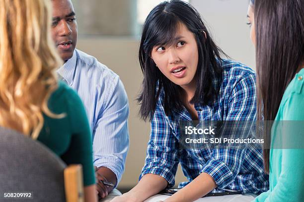 Young Asian Woman Expresses Concern In Support Group Stock Photo - Download Image Now
