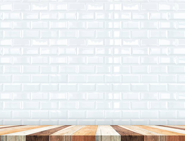 istock Empty tropical wood table top with white tiles wall 508211636
