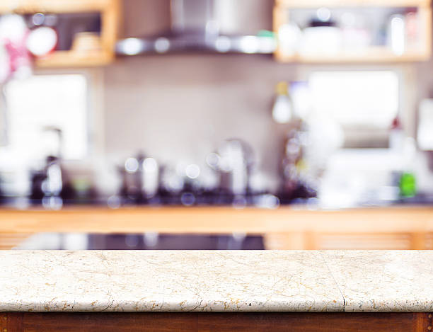 Empty marble table top and blurred kitchen bokeh light stock photo