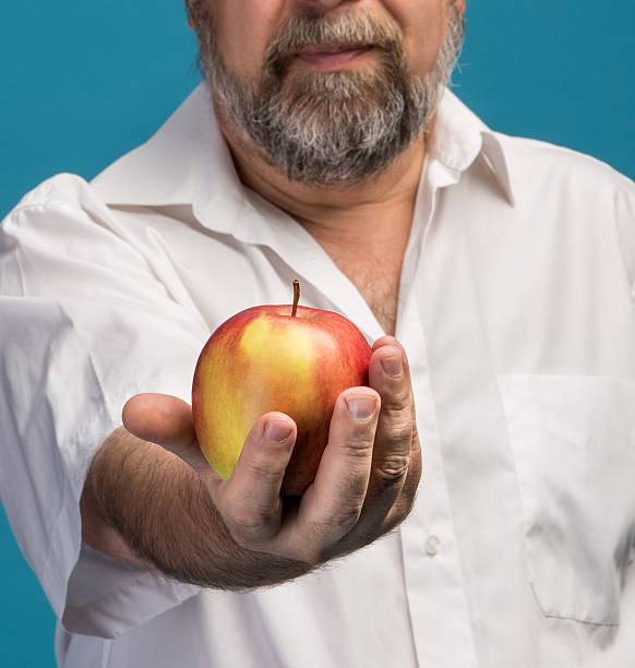 istock man holding red apple in hand 508212407