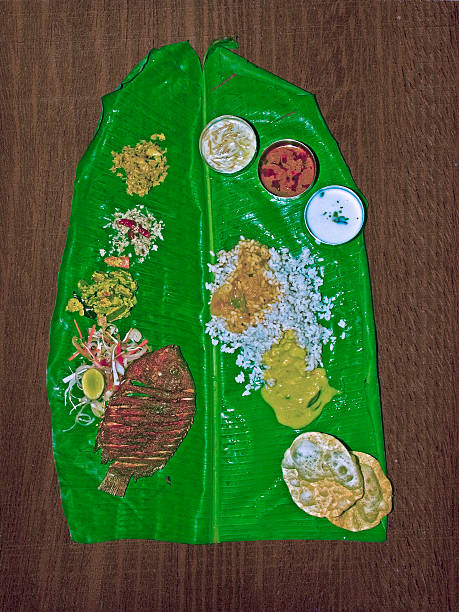 South Indian Thali (meals) with fish served traditionally on banana leaf