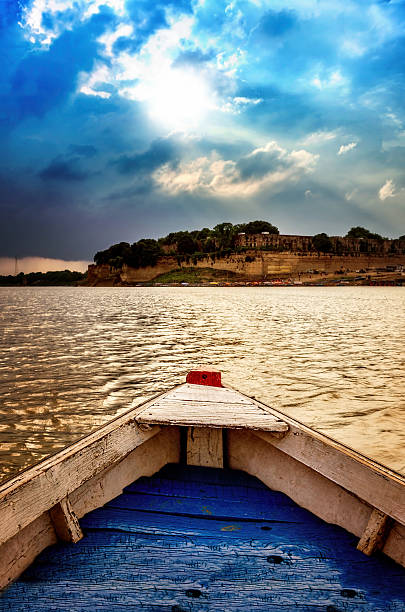 big wooden boats in water with cloudy sky and sunbeams big wooden boats in water with cloudy sky and sunbeams at allahabad indian asia prayagraj photos stock pictures, royalty-free photos & images