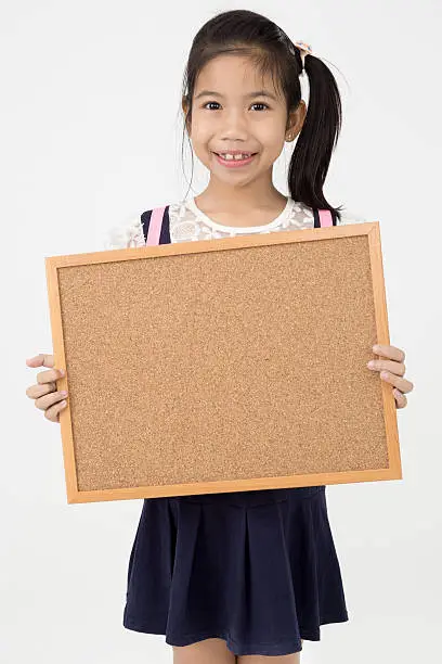 Asian girl hand holding woodboard  on gray background with smile face