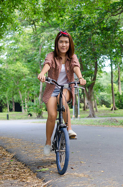 istock Rejoicing happy woman with mini bicycle in spring forest 508215035