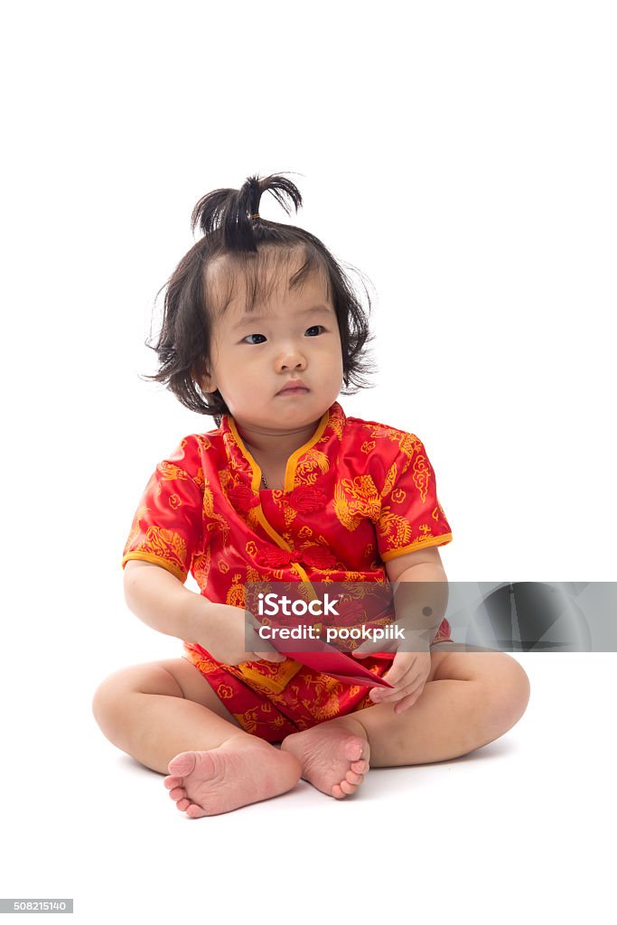 Cute Asian baby girl in traditional Chinese suit, red envelope Cute Asian baby girl in traditional Chinese suit with red envelope, Isolated on white background, Chinese New Year Concept Asian and Indian Ethnicities Stock Photo