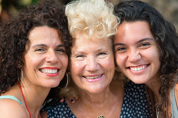 Three Generations Women Grandmother, mother and daughter laughing together grandmother real people front view head and shoulders stock pictures, royalty-free photos & images