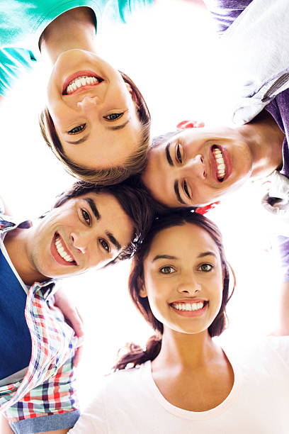 istock Happy Friends Forming Huddle Against Clear Sky 508216743