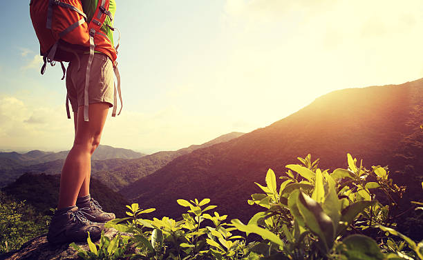 istock woman hiker legs stand on mountain peak rock 508218318