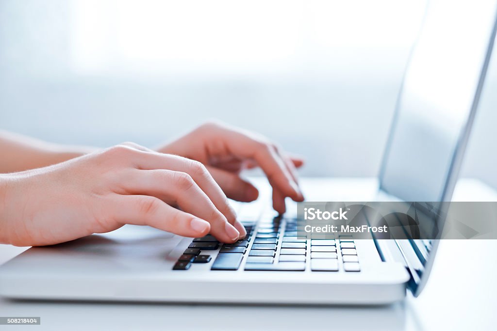 Woman's hands using laptop at the office Woman's hands using laptop at the office. Close-up image Adult Stock Photo
