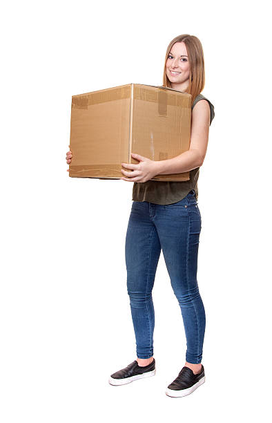 istock Young woman carrying moving boxes 508218622