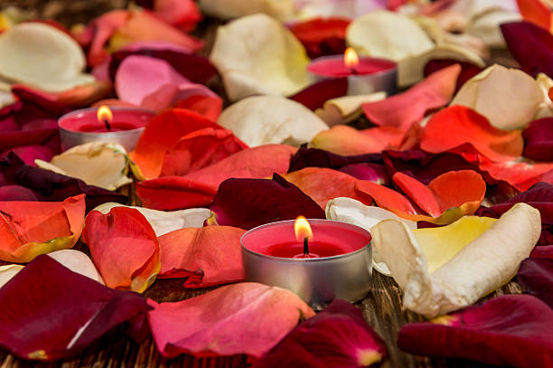 istock Candle with rose petals on wooden background 508222562
