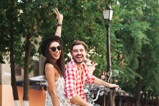 istock Young couple sitting on scooter and smiling 508222916