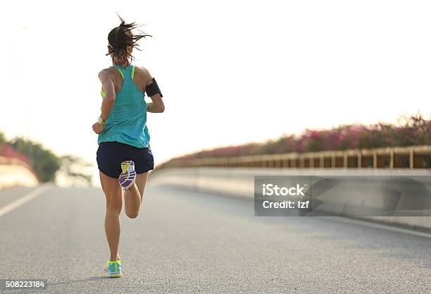 Young Woman Runner Running On City Bridge Road Stock Photo - Download Image Now - Running, Marathon, One Woman Only