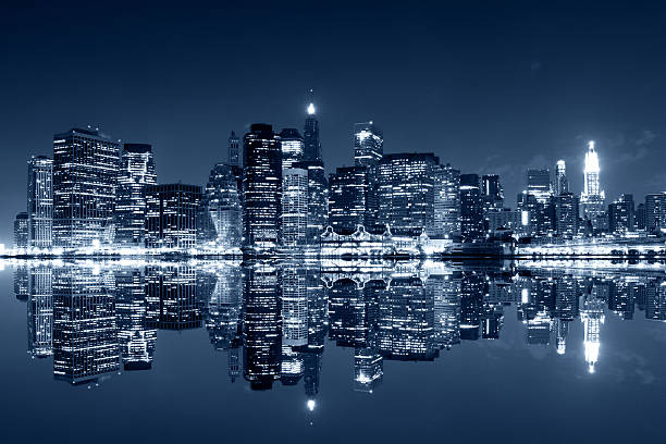 Manhattan at night with reflections on Harlem river stock photo