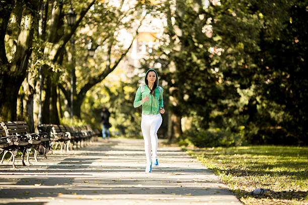 istock Young woman running in the park 508224148