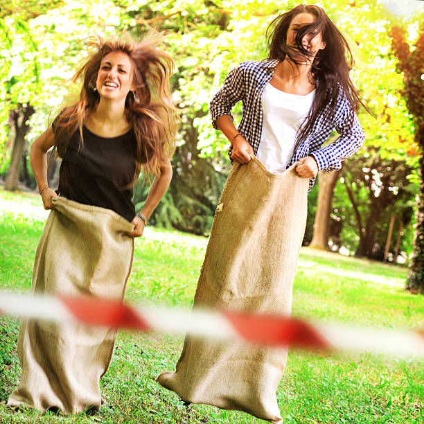 Two Young Woman Playing at Sack Race