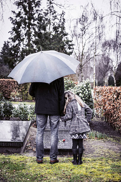 istock Father and daughter at mummy's gravestone 508229543