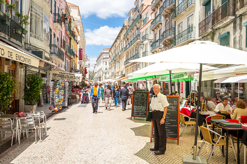 Lisbon, Portugal - May 26, 2014:  Unidentified tourists are walking at Santo Antao street  on May 26, 2014 at Lisbon ,Portugal. Santo Antao street is a lively pedestrian street known for its seafood restaurants.