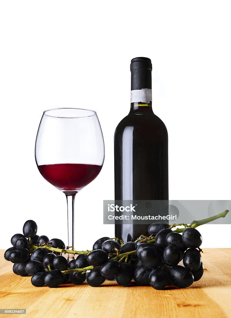 Red wine,glass and bottle on table. isolated on white Isolated on white Alcohol - Drink Stock Photo